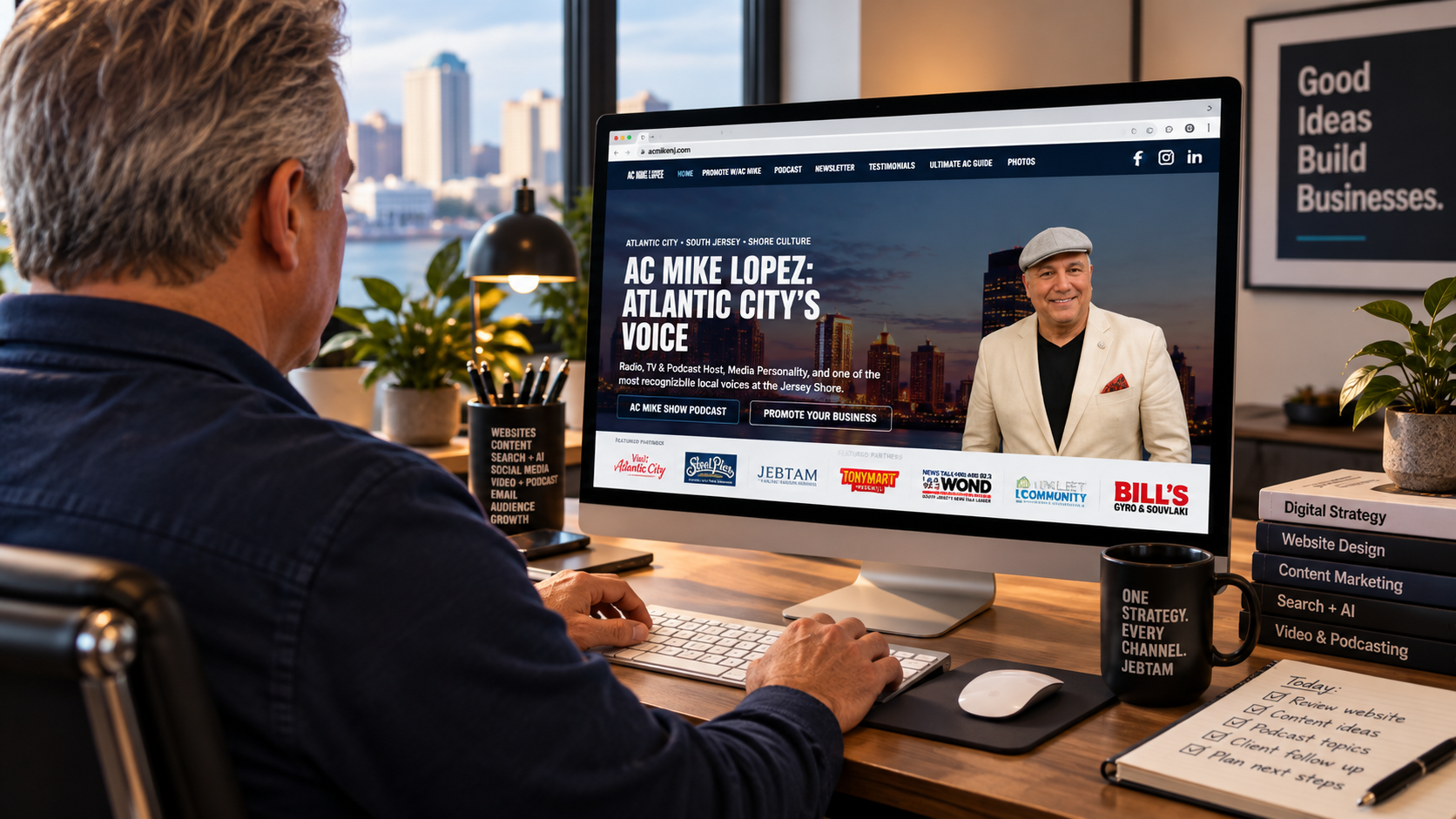 Business owner reviewing a website on a desktop computer as part of a broader digital brand strategy.